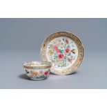 A fine Chinese famille rose cup and saucer with flowers and insects, Yongzheng