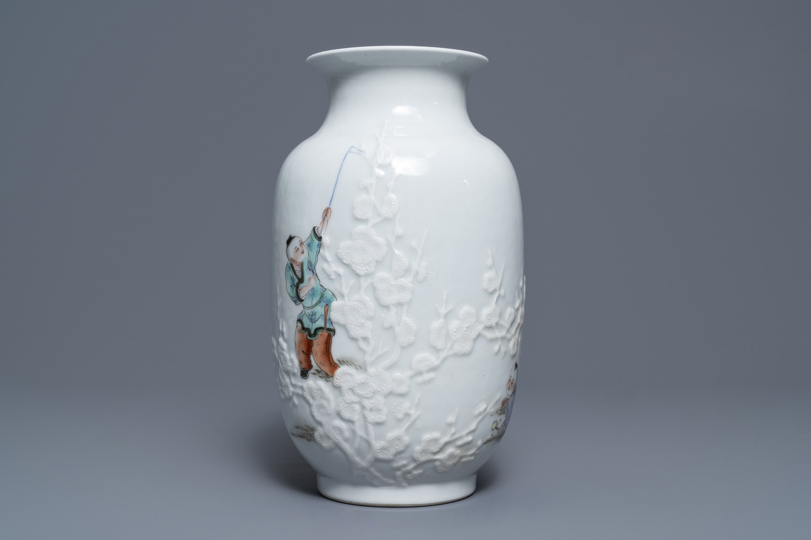 A Chinese famille rose relief-decorated vase with playing boys, Qianlong mark, Republic, 20th C. - Image 2 of 7