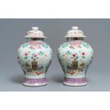 A pair of Chinese famille rose vases and covers with antiquities design, 18/19th C.