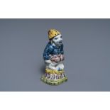 A rare polychrome Dutch Delft caster in the shape of a shitting man, 18th C.