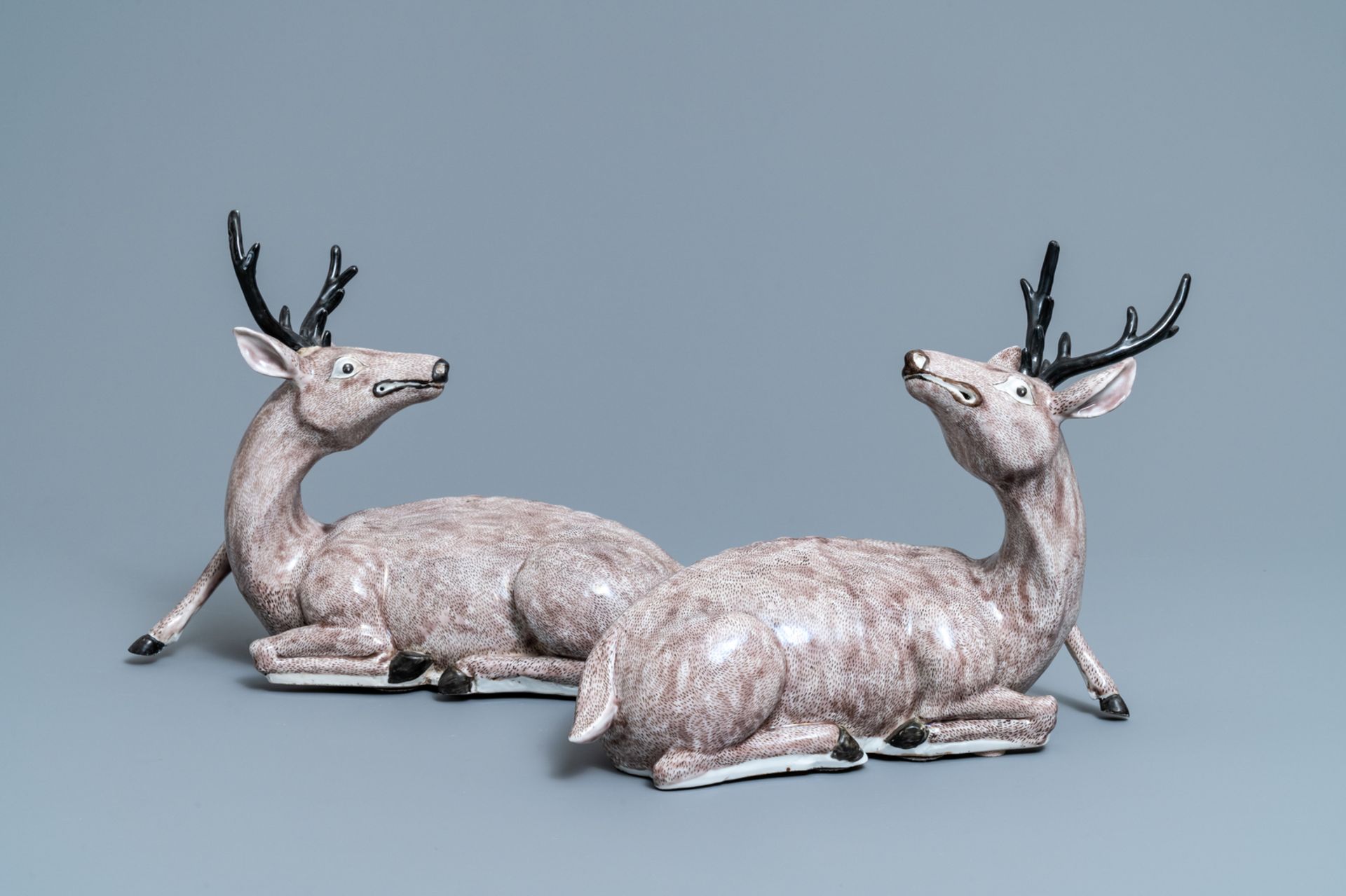 A pair of large Chinese aubergine-glazed models of recumbent deer, 18/19th C.