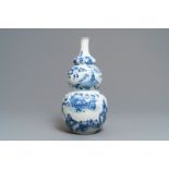 A Chinese blue and white triple gourd vase with circular landscape design, 19th C.