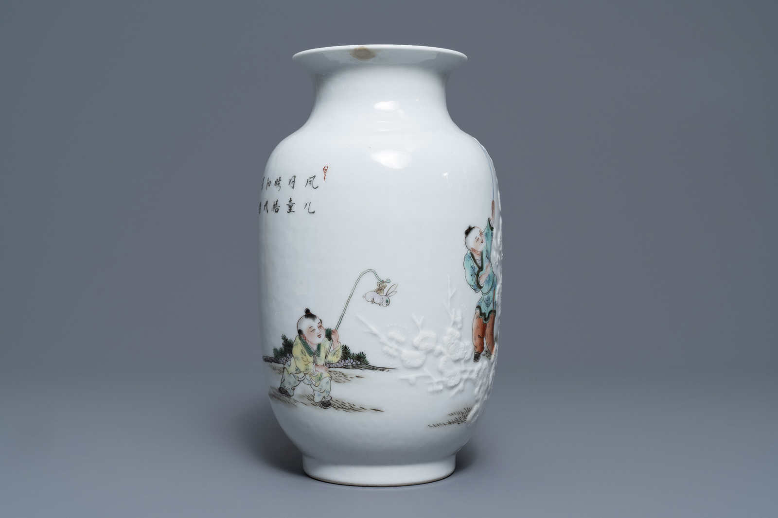 A Chinese famille rose relief-decorated vase with playing boys, Qianlong mark, Republic, 20th C. - Image 3 of 7