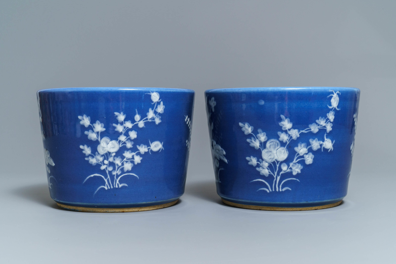 A pair of Chinese blue ground slip-decorated jardinires, 19th C.