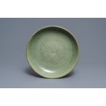 A Chinese Longquan celadon dish with underglaze peony design, Ming