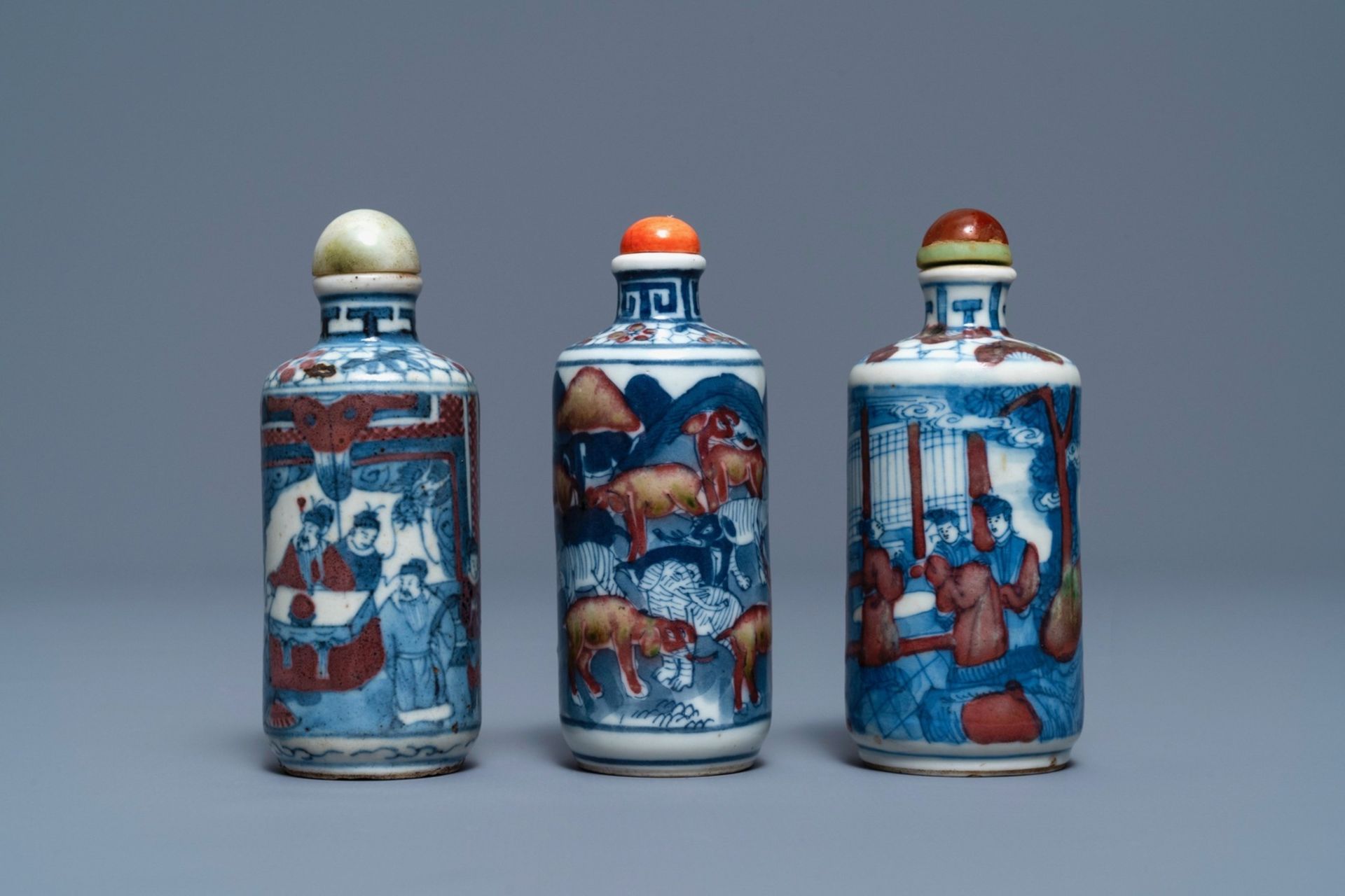 Three Chinese blue, white and underglaze red snuff bottles, Yongzheng marks, 19th C.