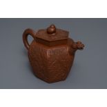 A large Chinese Yixing stoneware teapot with applied design, Kangxi