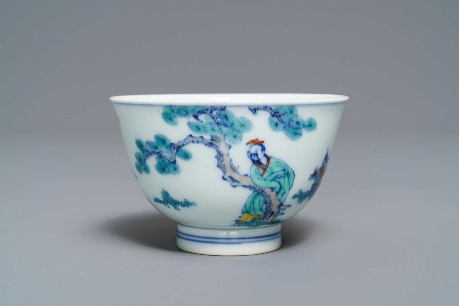 A Chinese doucai bowl with figures in a landscape, Kangxi mark, 19/20th C.