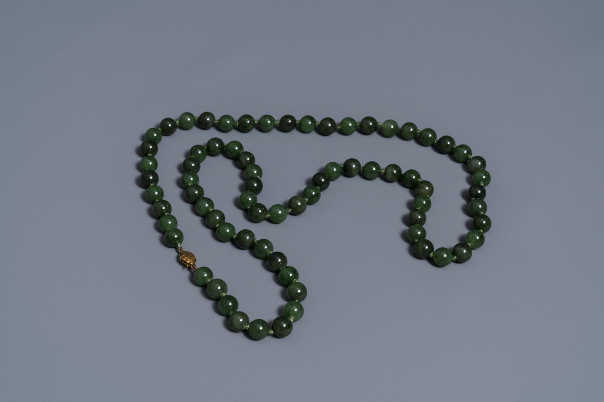 Two Chinese necklaces and a bracelet with spinach green jade beads, 20th C. - Image 4 of 5