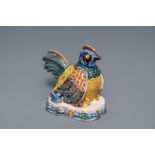 A polychrome Dutch Delft group of a hen with chickens, 18th C.