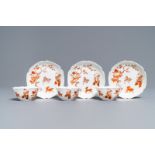 Three Chinese iron red eggshell cups and saucers with boys and goats, Yongzheng