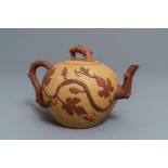 A large Chinese Yixing stoneware teapot with applied grape vines design, Kangxi