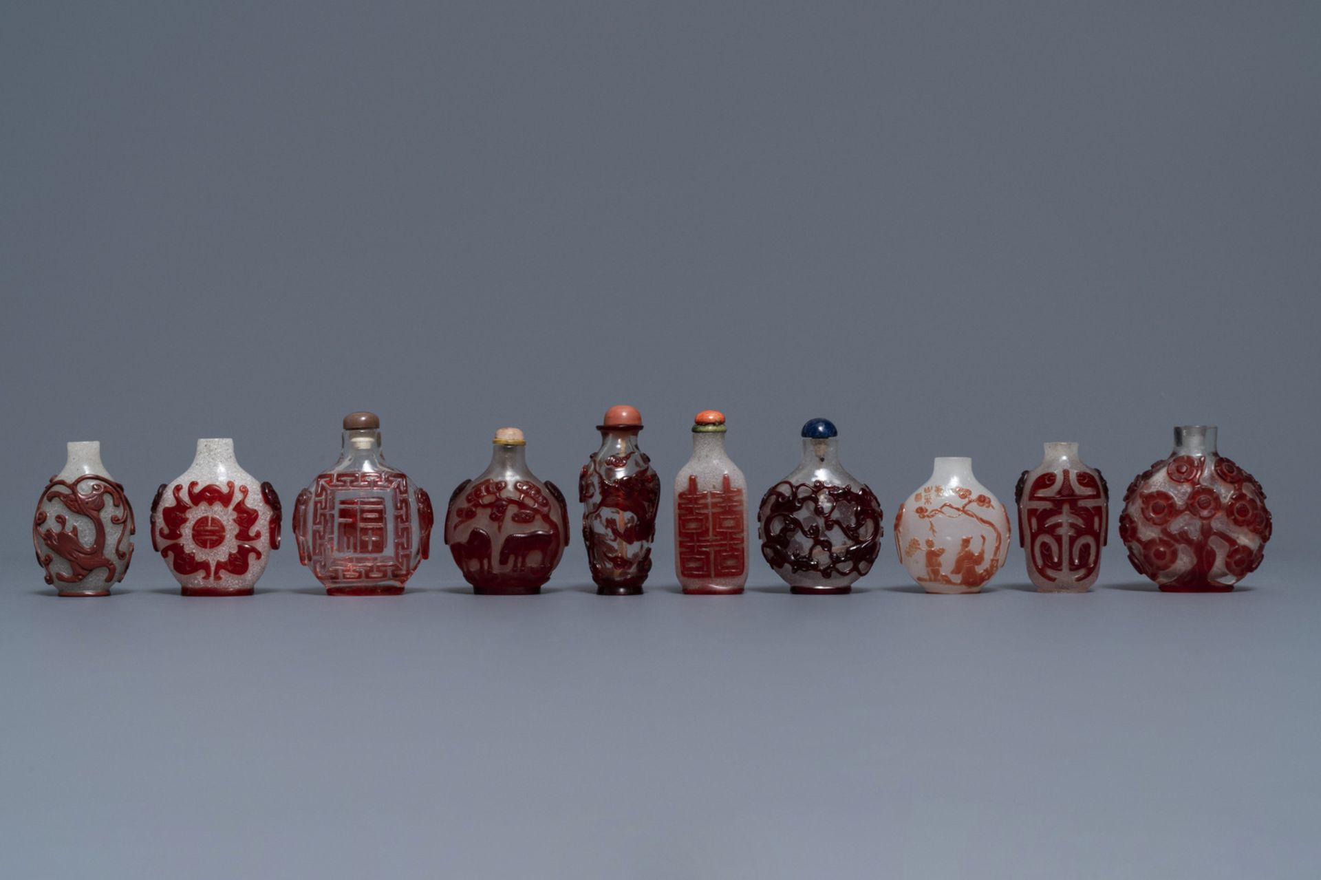 Ten Chinese red overlay, snowflake and transparent glass snuff bottles, 18/20th C.