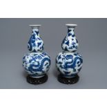 A pair of Chinese blue and white double gourd 'dragon' vases, Qianlong mark, 19th C.