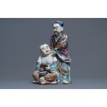 A Chinese famille rose group of two children, impressed marks, Republic, 20th C.