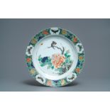 A Chinese famille verte charger with a bird, flowers and butterflies, Kangxi