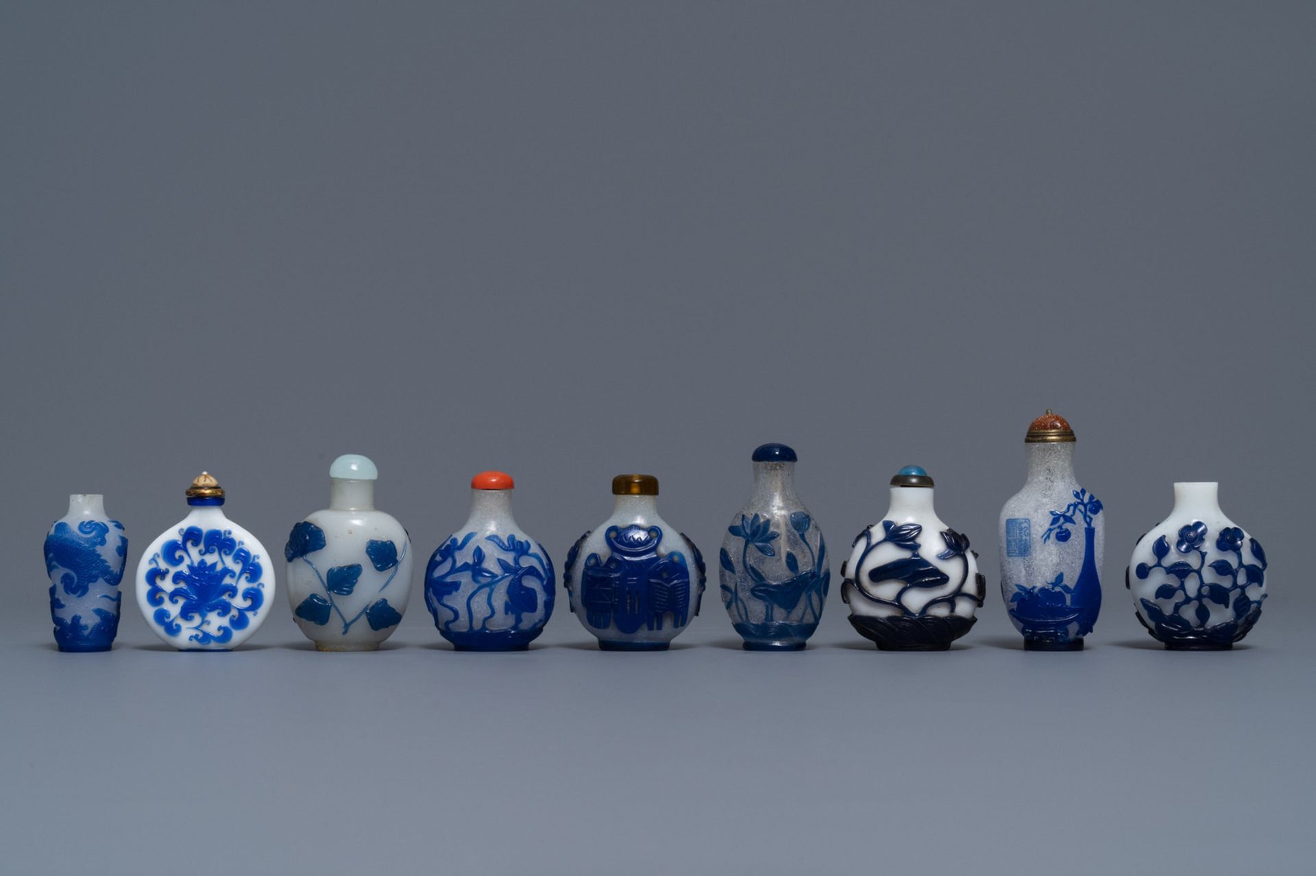 Nine various Chinese blue overlay glass snuff bottles, 19/20th C.