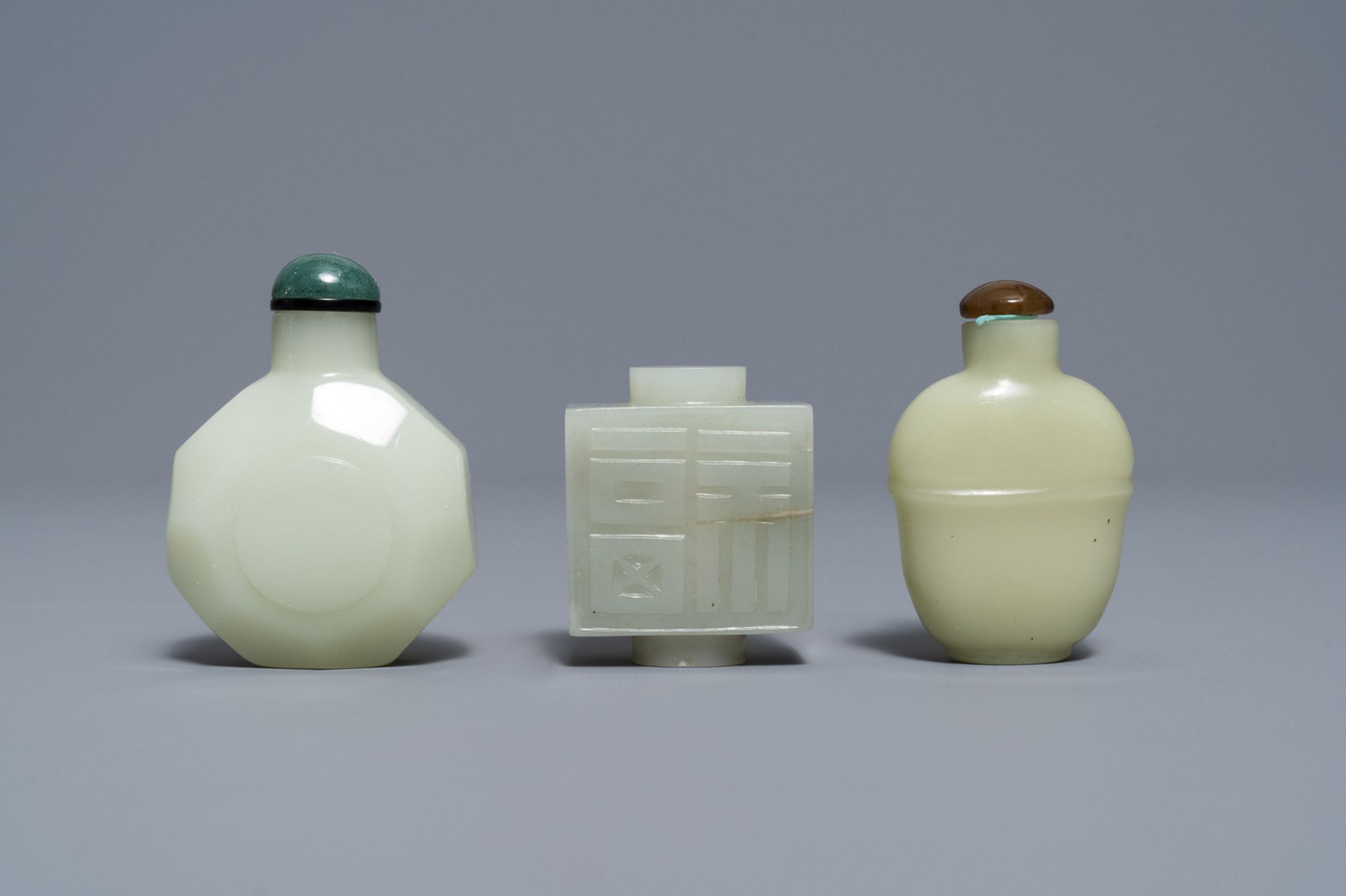 Three Chinese pale celadon jade snuff bottles, 19th C.