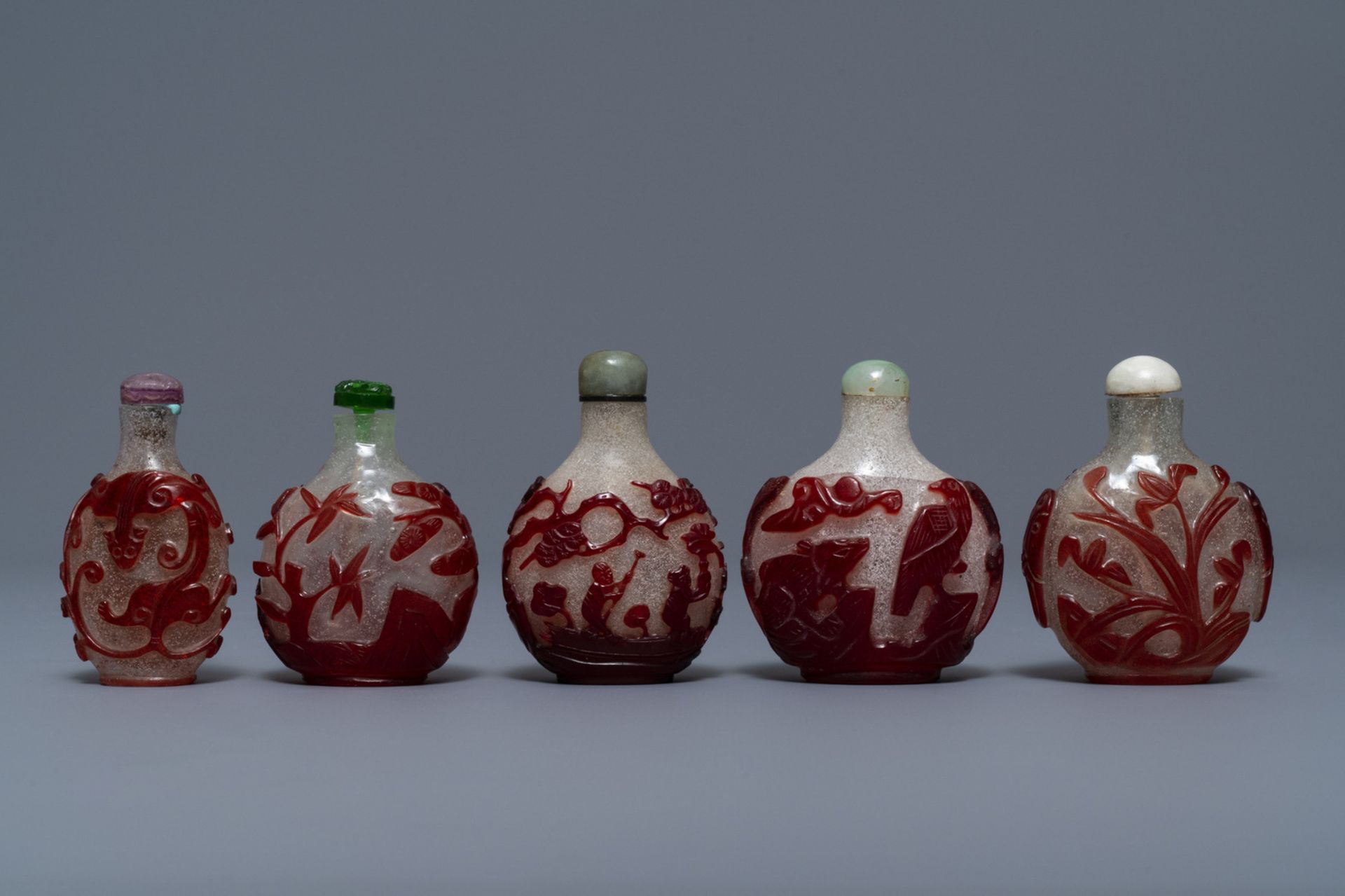 Five Chinese red overlay snowflake glass snuff bottles, 18/20th C.