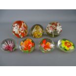 Seven vintage paperweights with floral type inclusion