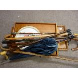 Two vintage wooden trays and one other and a quantity of walking sticks, canes and a vintage