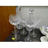 Two cut glass decanters and five long stem drinking glasses
