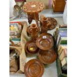 Two small Eastern carved folding wooden tables and a quantity of treen bowls etc