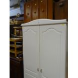 Modern white two door wardrobe, three drawer bedside chest and a mirror