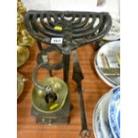 Two cast iron trivets, an antique brass and long handled iron pan with a vintage cast coffee