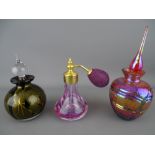 Two art glass scent bottles and a Caithness crackle glass example with puffer