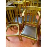 Three oak dining chairs and a matching carver