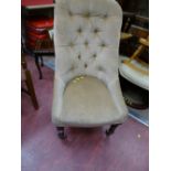 Button upholstered spoonback chair on brass castors