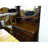 Bevelled edge mirror backed heavily carved sideboard with two drawers and two base cupboards
