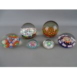 Six millefiori decorated glass paperweights