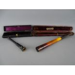 Two cased vintage cheroot/cigarette holders