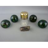 Four vintage paperweights, a carved hardstone buffalo and a silver topped smelling salts bottle