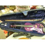 Purple coloured violin with standard bow in a fitted case