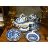 Parcel of blue Willow breakfast ware, an amber glass goblet and two brass based oil lamps