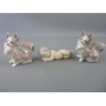 Three small Lladro figurines of a sleeping baby and a pair of Pomeranian terriers