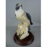 Country Artist's figurine of a falcon on a circular wooden base