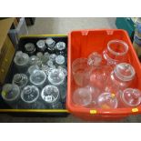 Two plastic crates of lidded and other glass storage jars