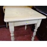 Modern light wood square topped kitchen table on turned supports