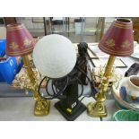 Bronzed effect table lamp in the form of an Art Deco figurine holding a globular shade and a pair of