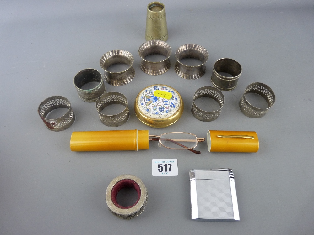 Enamel and brass paperweight, a quantity of white metal napkin rings and other collectables