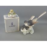 Two Lladro porcelain figurines including a pair of doves and a boxed model of a frog