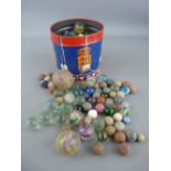 Collection of vintage glass and stone marbles in varying degrees of play worn condition