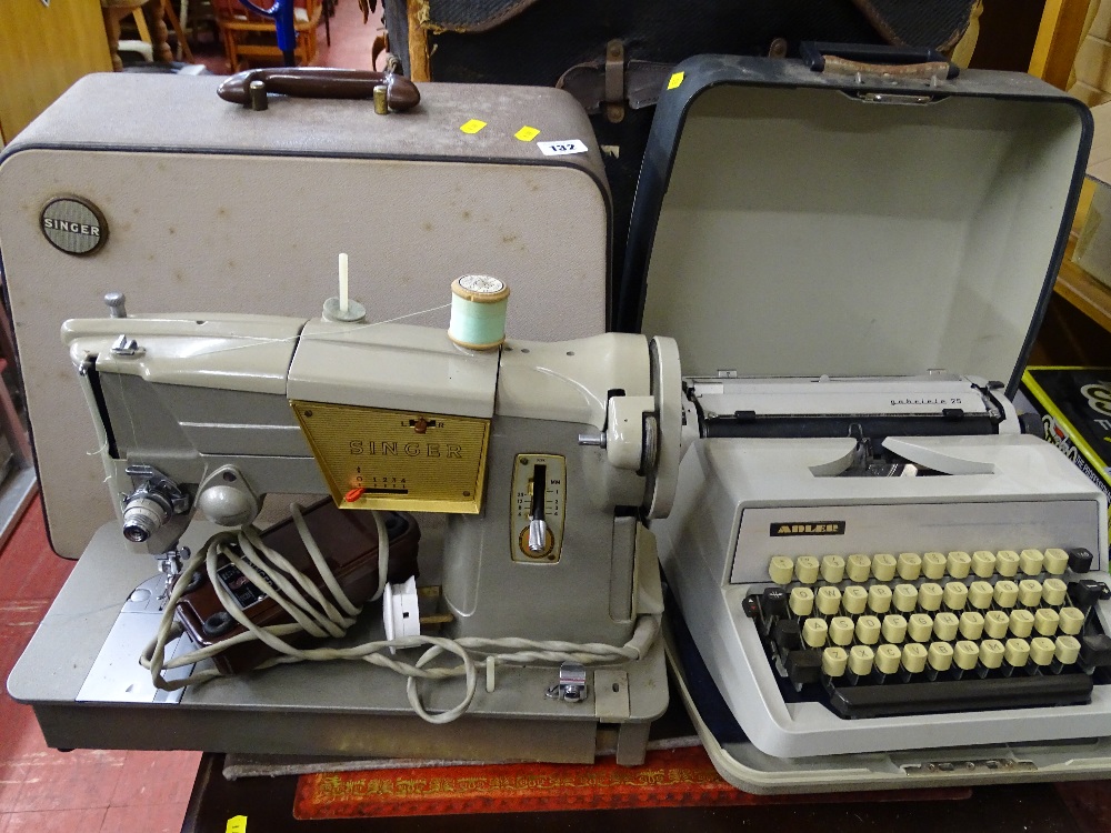 Cased Singer sewing machine and a cased typewriter