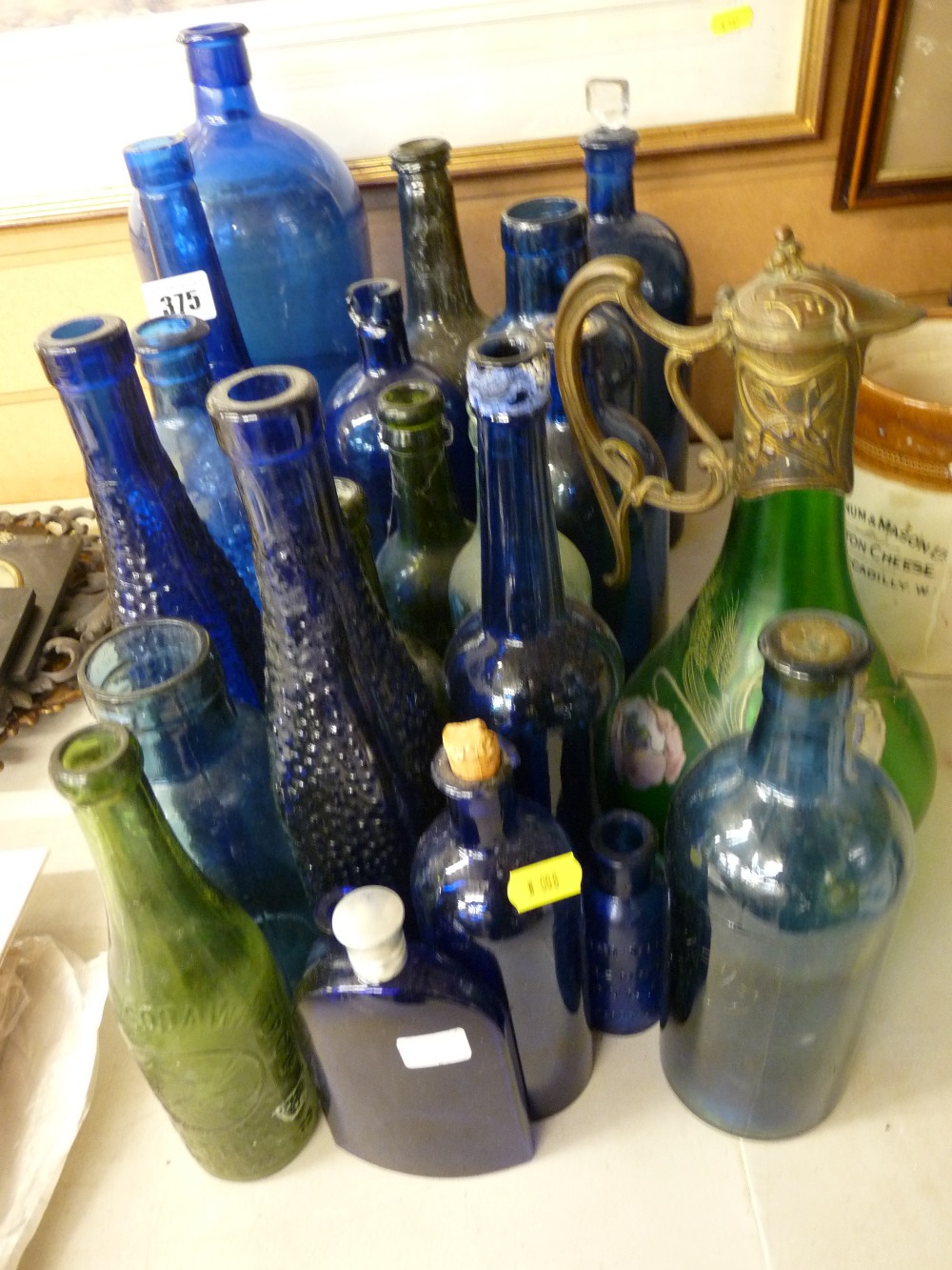 Collection of vintage mainly blue glass bottles and a possibly Austrian green glass claret jug