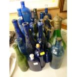 Collection of vintage mainly blue glass bottles and a possibly Austrian green glass claret jug