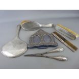 Four piece silver dressing table mirror, brush and comb set, an embossed hallmarked double